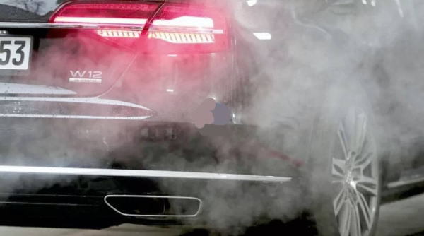 A luxury Audi car is surrounded by exhaust gases as it is parked with a running engine in front of the Chancellery in Berlin, Germany. — courtesy photo