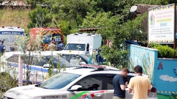 A view shows forensic technicians, ambulances and policemen outside a pre-school after a 25-year-old man attacked children, killing several and injuring others, according to local police and hospital, in Blumenau, in the southern Brazilian state of Santa Catarina, Brazil Wednesday. — courtesy Reuters