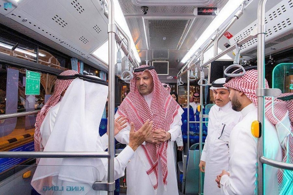 Prince Faisal bin Salman rides the electric bus after inaugurating the project.