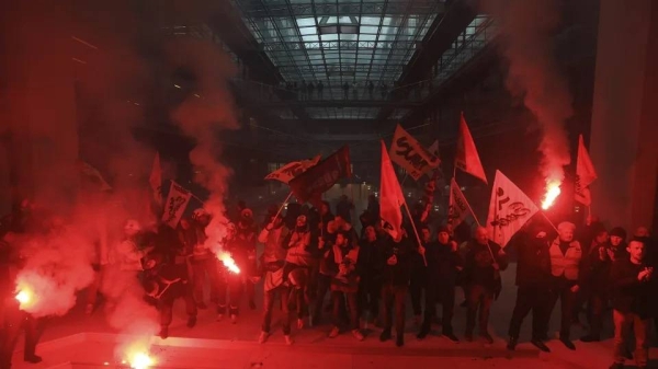 Workers invade the Centorial building that houses BlackRock's office in Paris on April 6, 2023.