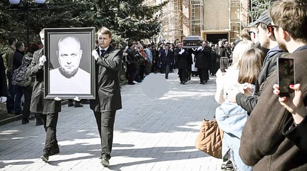 Pallbearers carry the coffin containing the body of military blogger Vladlen Tatarsky (real name Maxim Fomin) and his portrait, on Saturday. —courtesy AFP