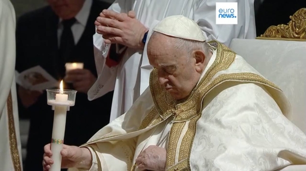 Pope Francis presides over a Easter vigil ceremony in St Peter’s Basilica at the Vatican, Saturday.