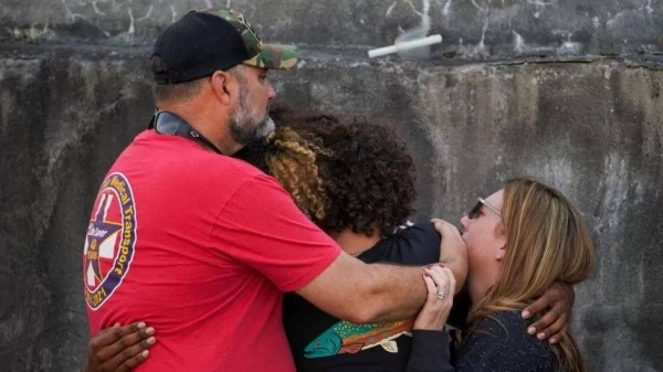 Members of the community in Dadeville, Alabama, consoled each other at a vigil on Sunday