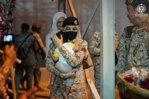 The Saudi woman soldier is seen cradling the baby boy as she disembarked from an evacuation ship at Jeddah Islamic Port on Monday.