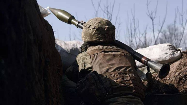 A Ukrainian soldier fires a grenade launcher on the frontline during a battle with Russian troops near Bakhmut, Donetsk region, Ukraine, Friday, March 24, 2023