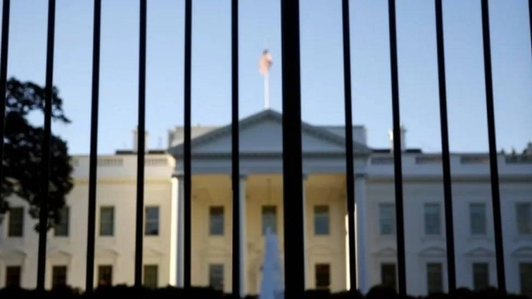 The White House seen through gates outside.