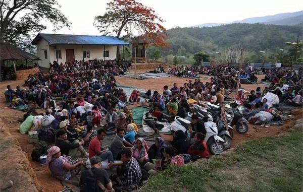 People fleeing ethnic violence wait at a temporary shelter in a military camp, after being evacuated by the Indian army