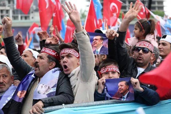 Supporters of Turkish President Recep Tayyip Erdogan cheer during his election campaign rally in Ankara, on April 30, 2023