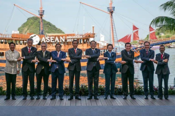 ASEAN leaders crossing arms for a 'family photo' at their summit in Labuan Bajo