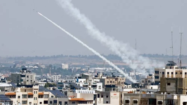 Palestinians in Gaza fired multiple barrages of rockets into Israel, leaving smoke trails across the sky. — courtesy Reuters