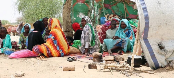 Sudanese refugees who fled the conflict in Sudan sit in makeshift shelters in Koufron, Chad. — courtesy WFP/Jacques David