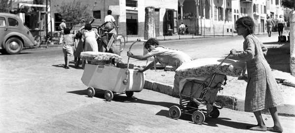 Barefoot and pushing their belongings in prams and carts, Arab families leave the coastal town of Jaffa which became part of the greater Tel Aviv area in the state of Israel. — courtesy UN Photo