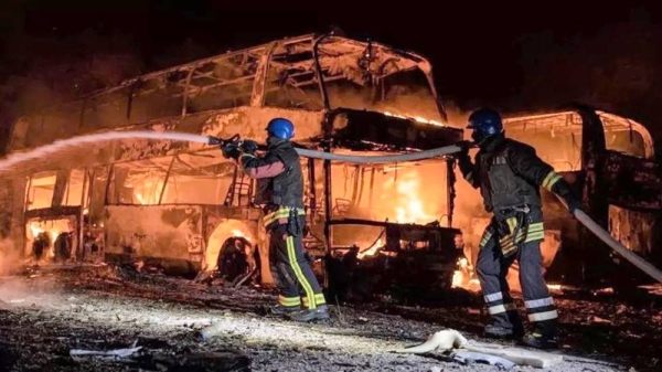 Firefighters use a hose to douse burning buses in Kyiv. — courtesy State Emergency Service of Ukraine