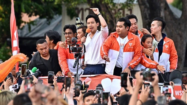 Move Forward Party leader Pita Limjaroenrat leads a victory parade with fellow party members and supporters outside Bangkok City Hall on May 15