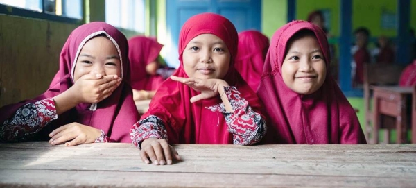Girls await their turns to get immunized at Rusung Raya Elementary School, in Indonesia. — courtesy UNICEF/Clark