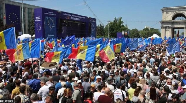 Moldovans wave EU flags during a pro-European rally in Chisinau