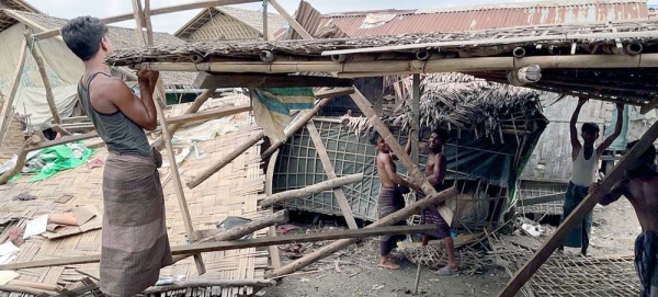 Men repair a shelter damaged by Cyclone Mocha in Nget Chaung 2 IDP camp in Rakhine state in Myanmar. — courtesy UNOCHA/Pierre Lorioux