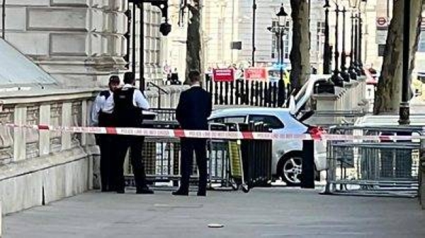 Footage of the car, identified as a silver Kia, shows it slowing down as it approaches the main entrance to Downing Street. (BBC)