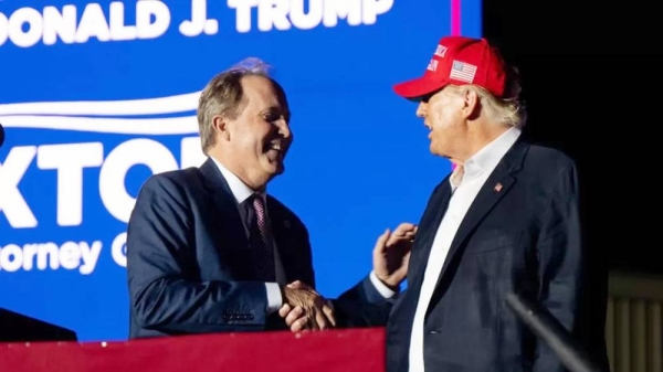 Texas Attorney General Ken Paxton (left) and former US President Donald Trump greet one another at a rally for Trump in Texas last year. — courtesy Getty Images
