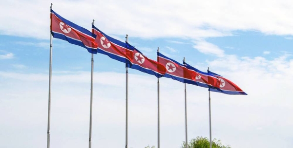 Flags of the Democratic People's Republic of Korea fly in Pyongyang. — courtesy Unsplash/Micha 