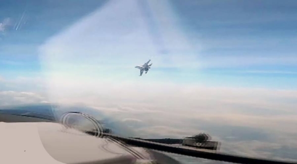 Chinese fighter jet flies close to US military plane.