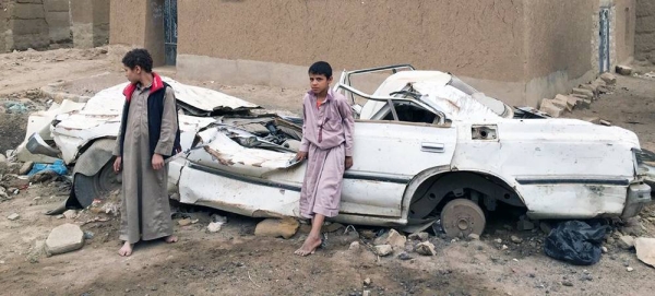 Young boys stand in front of a damaged vehicle in Sa’ada, Yemen. — courtesy WFP/Jonathan Dumont