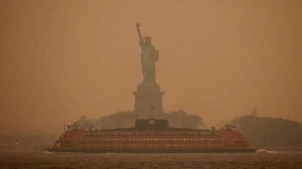 In New York, photos taken on Tuesday morning showed an orange haze blanketing the city's skyline.