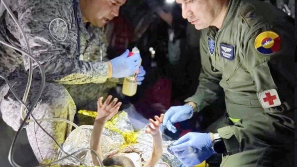 Rescue workers prepare bottle for baby. — courtesy photo from President Gustavo Petro