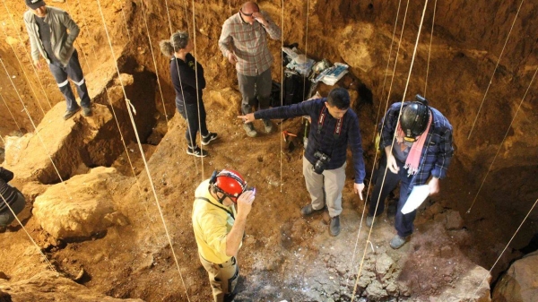 Archaeologists are shown here working at Tam Pa Ling cave in northeastern Laos