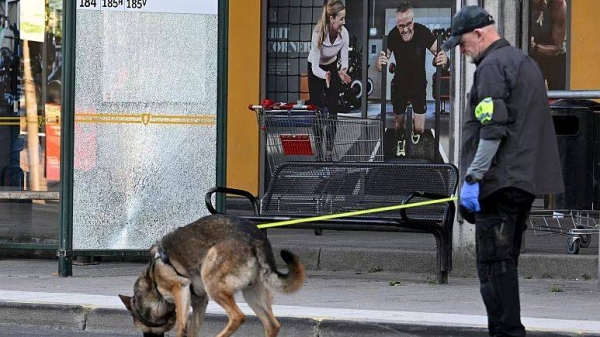 Police at the scene after a shooting incident in southern Stockholm