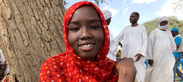 A young girl who fled Sudan with her family waits for a distribution of relief aid in Chad. — courtesy UNICEF/Donaig Le Du