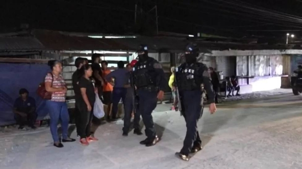 Police patrol near the scene of the shooting in Choloma