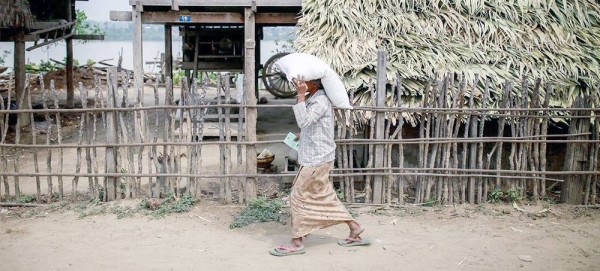 File photo shows a woman carries a sack of fertilizer distributed by the UN in Yin Yane Village, Monywa, Myanmar. — courtesy FAO/Hkun Lat