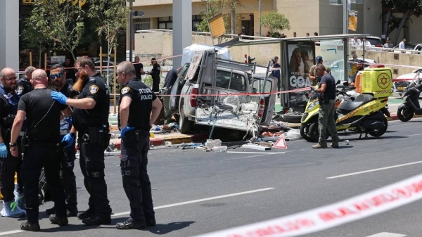 Members of Israeli security and emergency personnel work at the site of the car ramming attack in Tel Aviv on July 4, 2023.