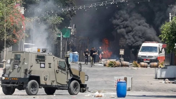 Israeli military vehicle confronting Palestinian youths in Jenin on July 3.