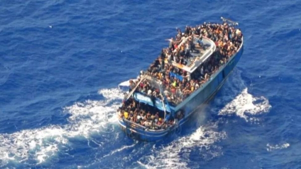 A photo provided by the Greek coastguard shows migrants on board the crowded fishing vessel, 14 June 2023