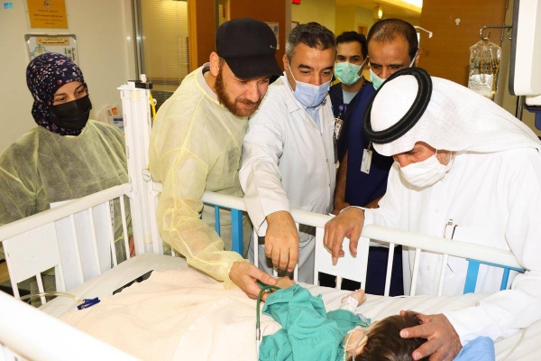 Dr. Abdullah Al Rabeeha examining Syrian twin Bassam.