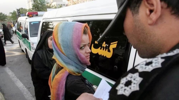 File photo shows morality police officer questions Iranian woman. — courtesy Reuters