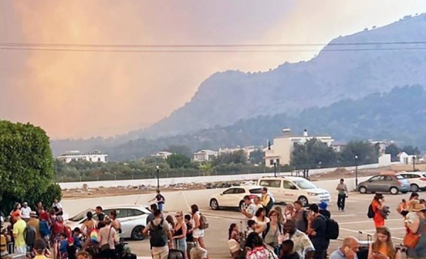 Tourists gather outside after being evacuated from their resort hotels