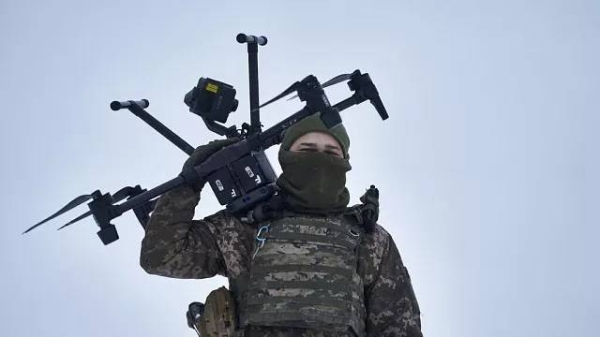 A Ukrainian soldier carries a drone close to the frontline near Avdiivka, Donetsk region, Ukraine, Friday, Feb. 17, 2023.