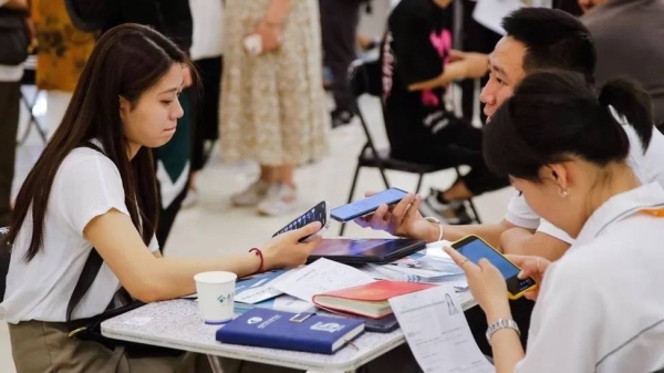 Job seekers and recruiters at a job fair in Beijing