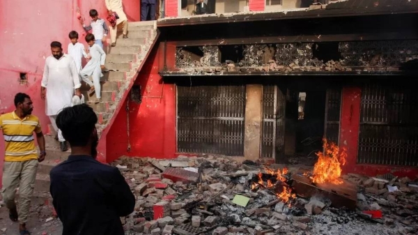 Smouldering flames litter the ruins of a church in Jaranwala, Pakistan