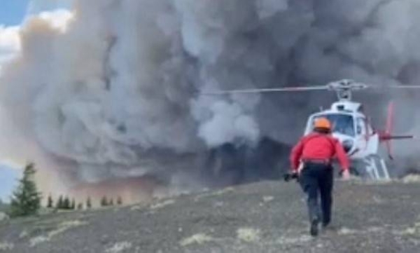 A dramatic helicopter rescue for three hikers trapped by wildfire in Canada