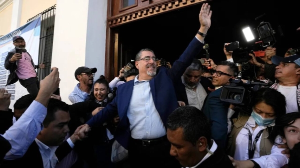 Presidential candidate Bernardo Arévalo waves after voting in Guatemala City on Aug. 20, 2023.