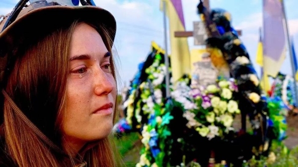 Flags fly above soldiers' graves in a cemetery in Lviv