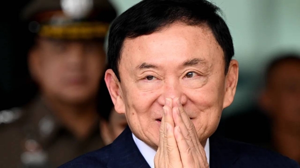 Former Thai prime minister Thaksin Shinawatra greets supporters as he arrives at Don Mueang International Airport on August 22 in Bangkok, Thailand.