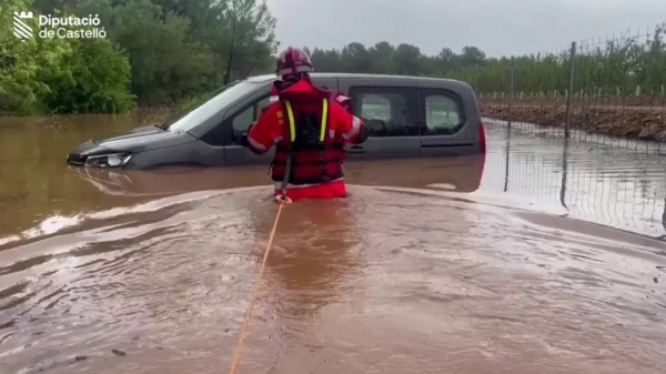 One man had to be rescued from his car by a firefighter in Spain's eastern Castelló province