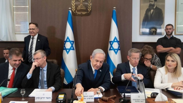 Israeli Prime Minister Benjamin Netanyahu eats an apple slice to mark the upcoming Jewish New Year holiday at a weekly meeting of his cabinet on September 10.