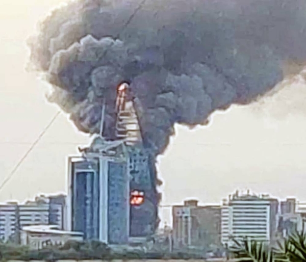 Flames and dark smoke rise from the iconic Khartoum skyscraper. — courtesy AFP