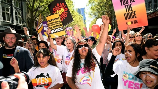 Crowds march during a 'Walk for Yes' rally in Melbourne on September 17, 2023.